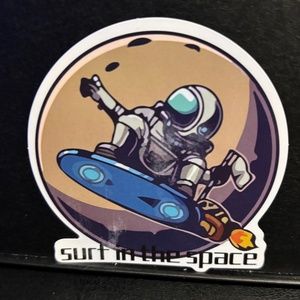 SURFING ASTRONAUT STICKER